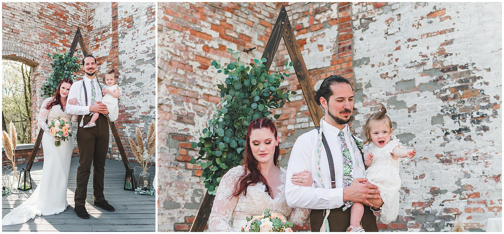 Bride, groom, and daughter take portraits together after the wedding ceremony at the Hackney Warehouse