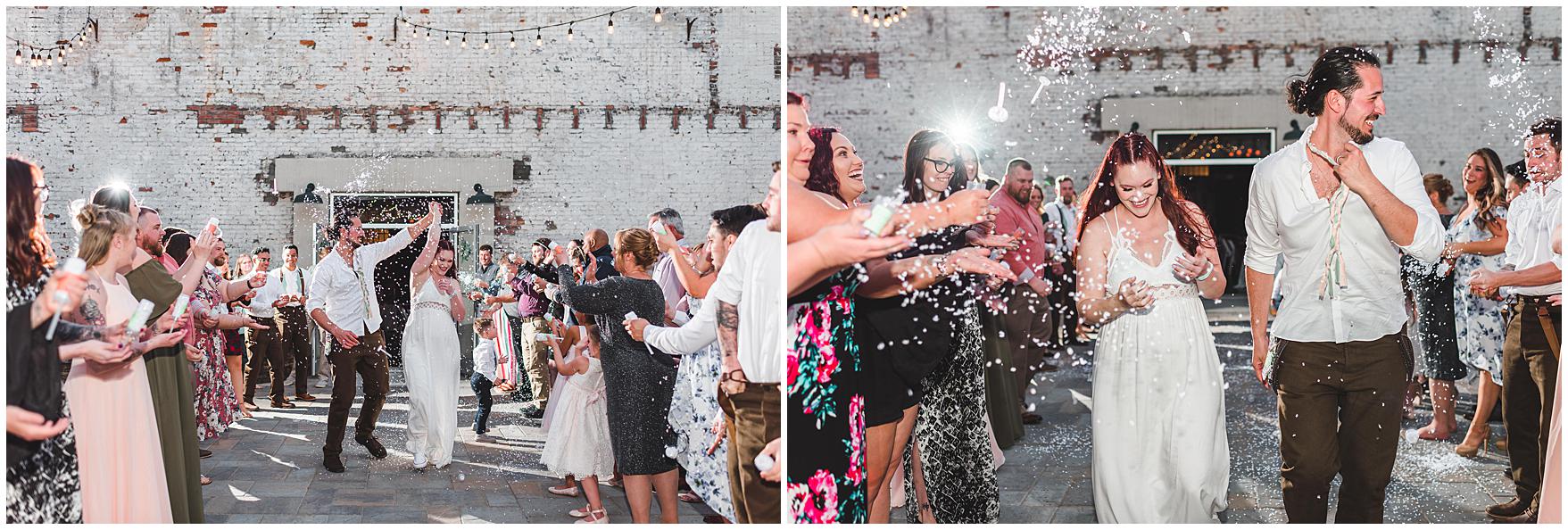 Bride and groom share a confetti exit on their wedding day