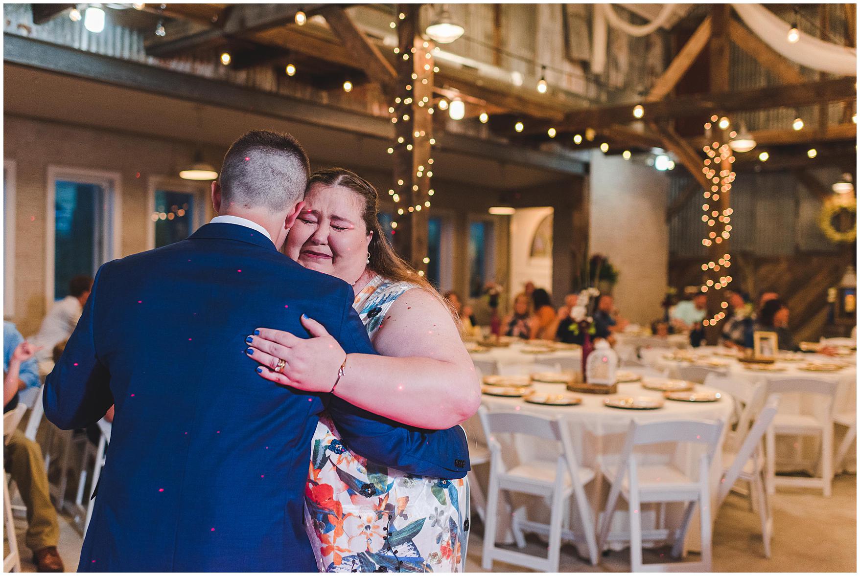 mother and son dance at a barn wedding