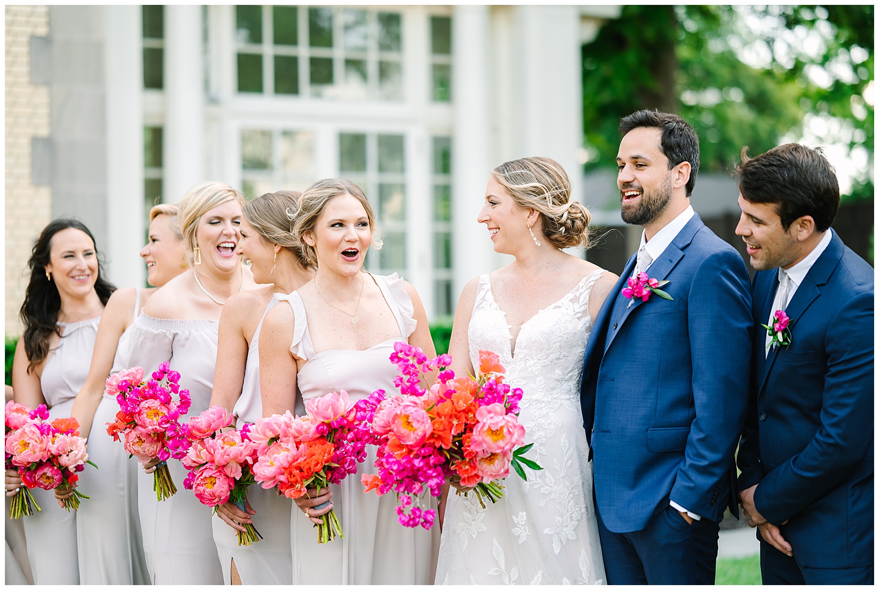 Charlotte wedding photographer captures wedding party laughing outside of Separk Mansion on Charlotte wedding day
